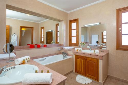 a large bathroom with a tub and a sink at Domaine Abiad in Marrakesh