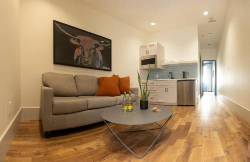 a living room with a couch and a table at The Thomas Hotel - Premium Square View Suite in Tyler