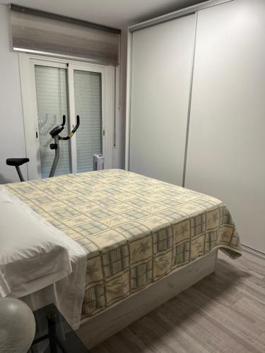 a bedroom with a bed in a room with windows at Ca La Luci in San Juan de Palamós