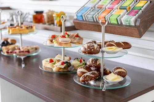 a counter with several plates of pastries on display at Johanniter Gästehaus in Münster