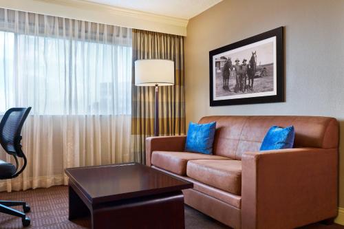 a living room with a couch and a table at Sheraton North Houston at George Bush Intercontinental in Houston