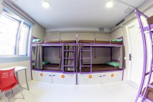 a room with two bunk beds in a bus at Scout Madrid Hostel in Madrid