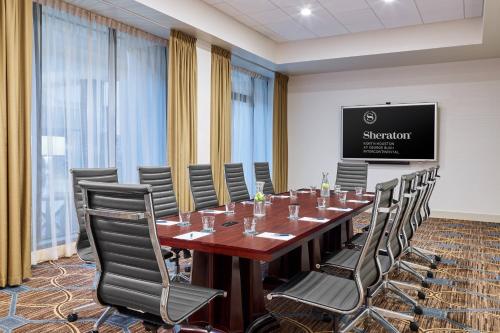 a conference room with a long table and chairs at Sheraton North Houston at George Bush Intercontinental in Houston