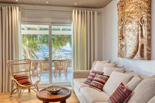 a living room with a couch and a table at Santa Marina, A Luxury Collection Resort, Mykonos in Ornos
