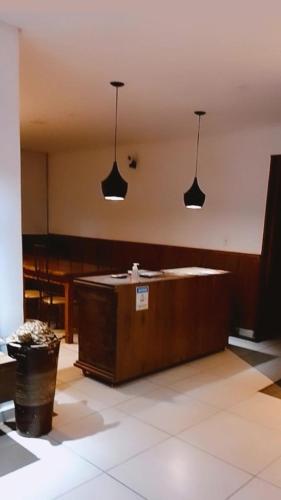 a large room with two lights hanging from the ceiling at Pippo Suites Guarujá in Guarujá