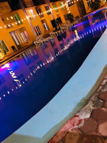 a reflection of buildings in a body of water at night at VILLAS RIBERA DEL PACIFICO in Ixtapa