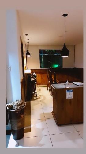 a kitchen and dining room with a table and chairs at Pippo Suites Guarujá in Guarujá