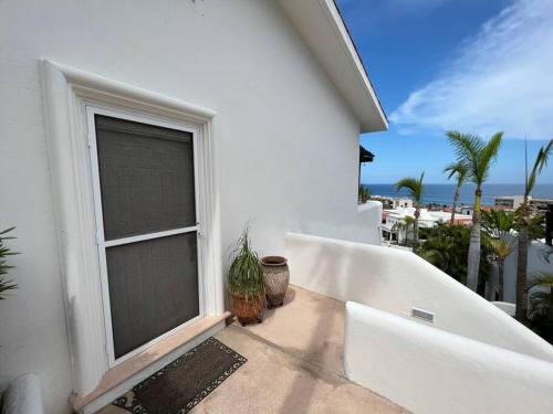 a balcony with a window and a view of the ocean at Upscale 2bdrm Condo In La Jolla in San José del Cabo