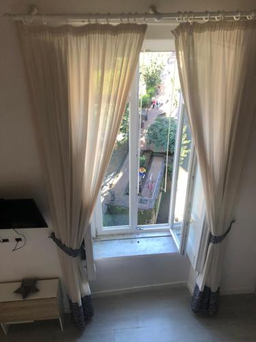 a room with a large window with curtains at B&B Neapolis Bellini in Naples