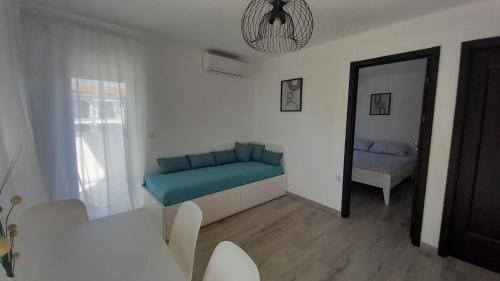 a living room with a couch and a mirror at Apartmani HERMES Jadrija in Šibenik