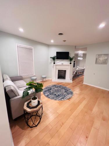 a living room with a couch and a fireplace at Cozy 1/1 near Piedmont Park ATL in Atlanta