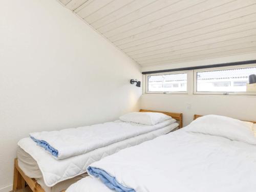 two beds in a room with white walls at Holiday home Vejers Strand XXI in Vejers Strand