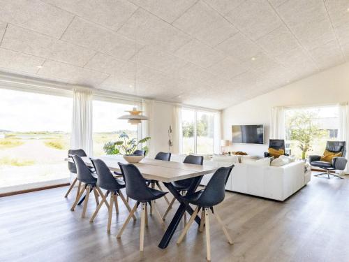 a dining room with a table and chairs and a couch at Modern Retreat in Graerup - By Traum Ferienwohnungen in Oksbøl