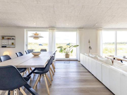 a dining room with a long table and chairs at Modern Retreat in Graerup - By Traum Ferienwohnungen in Oksbøl