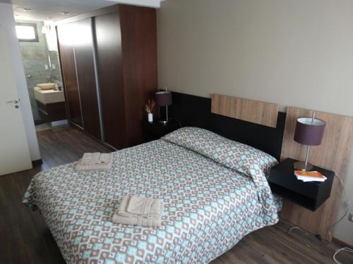 a bedroom with a bed with two towels on it at Sol y Montaña in San Juan