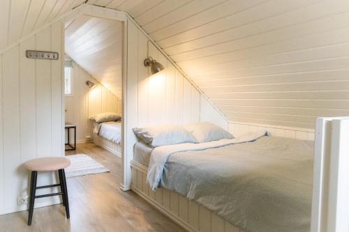 a bedroom with a bed in a room with a mirror at The Buar Cabin in Strömstad