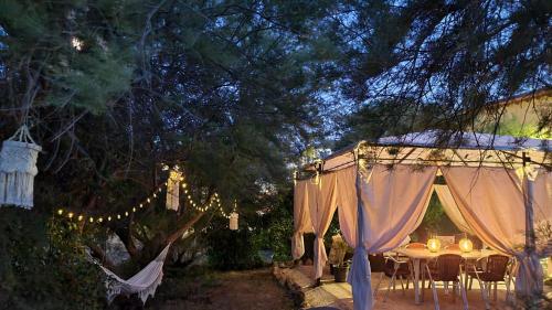 a table and chairs under a tent with lights at Las Golondrinas de Henche in Henche