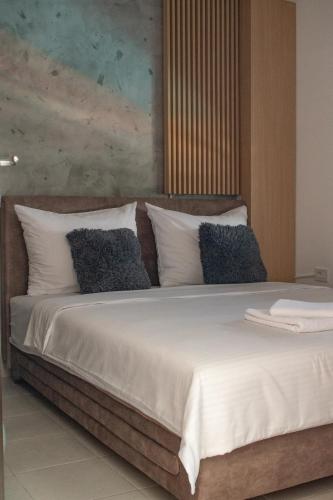 a bedroom with a large bed with white sheets and pillows at Bella Vista in Jagodina