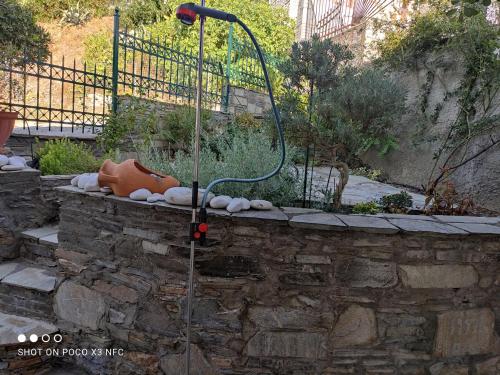a shower in a stone wall with a hose at MESONISI maisonette in Afissos
