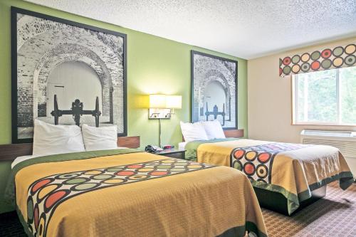 a hotel room with two beds and two windows at Super 8 by Wyndham Augusta Ft Eisenhower Area in Augusta