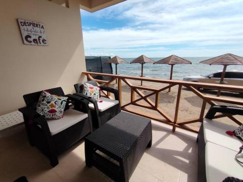 a balcony with chairs and a view of the ocean at Suite privada frente al mar. in San Silvestre