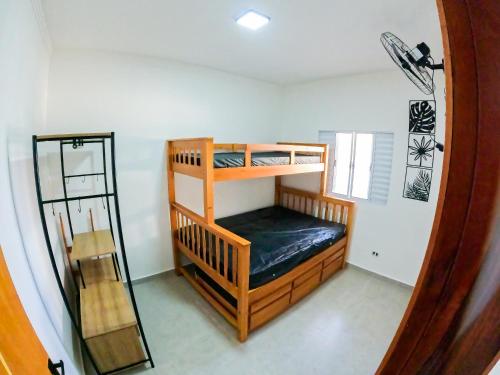 a room with two bunk beds and a mirror at Ubatuba Prime House ap13 in Ubatuba