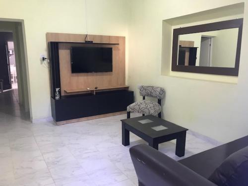 a living room with a couch and a tv and a table at comoencasa2 in Mercedes