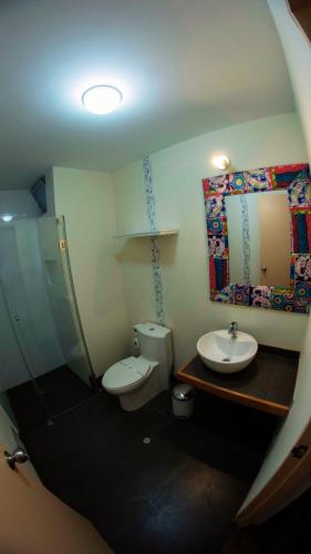 a small bathroom with a toilet and a sink at Atrium Miraflores Hotel in Lima