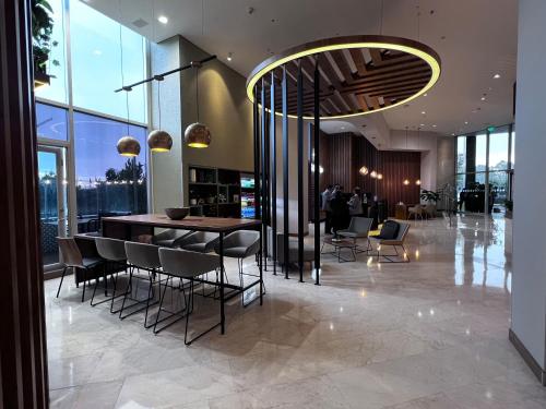 a lobby with a bar and chairs in a building at Holiday Inn Bogota Airport by IHG in Bogotá