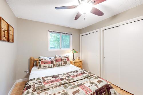a bedroom with a bed and a ceiling fan at Hillis House in Arbor Vitae