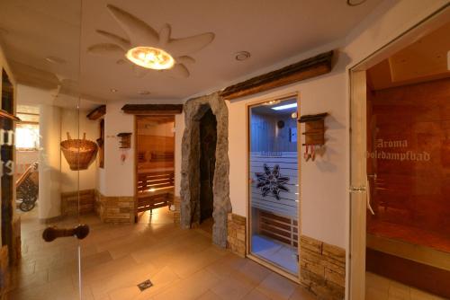 a hallway with a shower and a glass door at Boutique Hotel Mandarfnerhof in Sankt Leonhard im Pitztal
