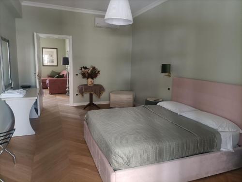 a bedroom with a bed and a living room at La luna piena in centro in Pescara