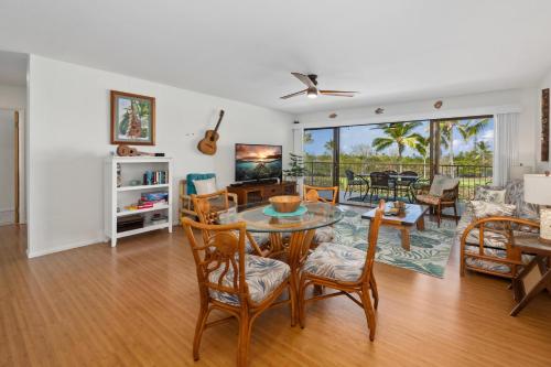 a living room with a table and chairs at Big Island Keauhou Punahele E202 condo in Kailua-Kona