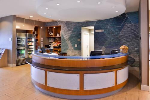 a lobby with a circular counter in a hotel at SpringHill Suites by Marriott Corona Riverside in Corona