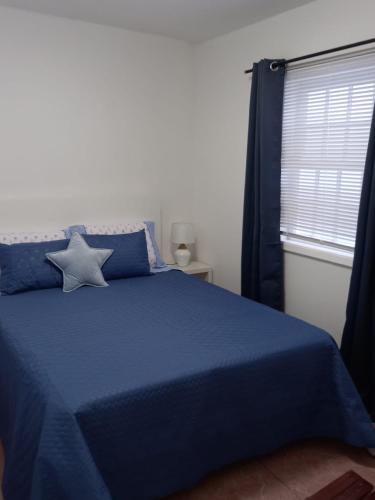 a bedroom with a blue bed with a star on it at SEASTAR nº38 in Horta