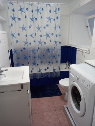 a bathroom with a toilet and a washing machine at SEASTAR nº38 in Horta