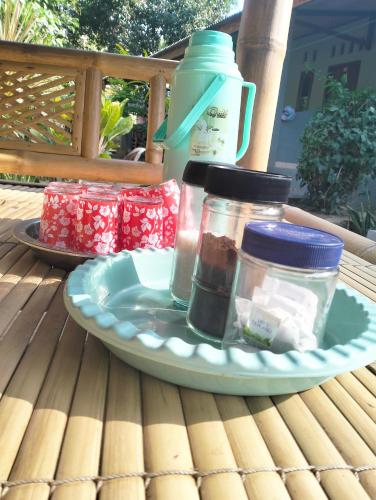 a plate with jars of food on a table at T&T Homestay in Kuta Lombok