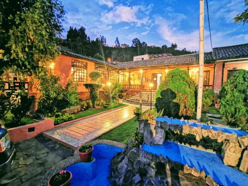 an exterior view of a house with a garden at QUINTA LOREN HOSTERIA in Ambato