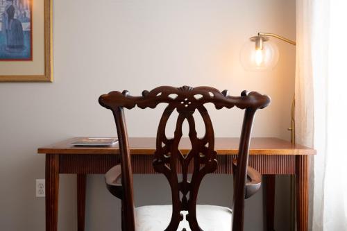 a wooden chair sitting in front of a desk at Luxury Federal Hill Home with Rooftop & 4 Parking Spots in Baltimore