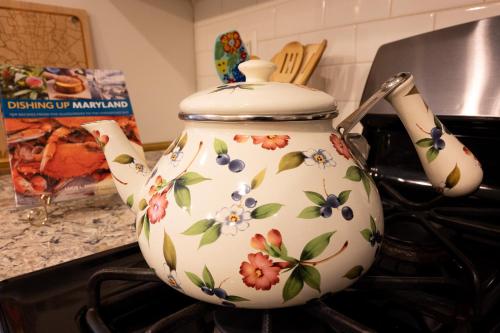 a tea pot sitting on top of a stove at Luxury Federal Hill Home with Rooftop & 4 Parking Spots in Baltimore