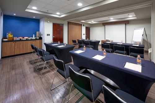 a conference room with tables and chairs and a podium at City Express by Marriott Saltillo Norte in Saltillo