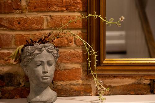 a statue of a head in front of a mirror at Luxury Federal Hill Home with Rooftop & 4 Parking Spots in Baltimore