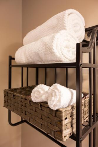a towel rack with towels and a basket on it at Luxury Federal Hill Home with Rooftop & 4 Parking Spots in Baltimore