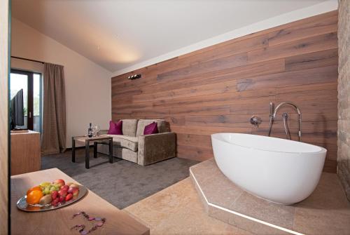 a bathroom with a large tub in a room at Hotel Restaurant Kirchsteiger in Vollan