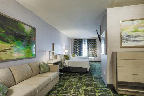 a hotel room with a bed and a couch at SpringHill Suites Prescott in Prescott