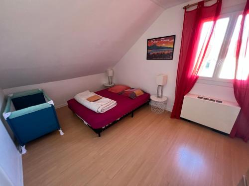 a small bedroom with a bed and red curtains at Villa à Gap in Gap