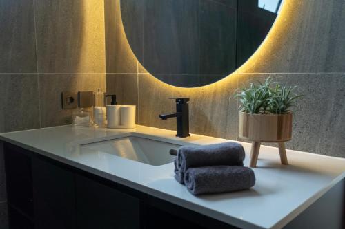 a bathroom with a sink and a mirror at Balisen Luxury Villas in Jasri