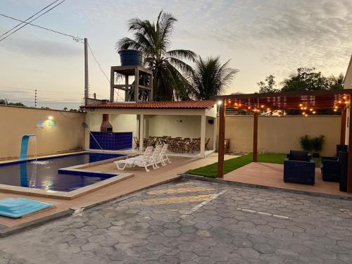 a backyard with a swimming pool and a house at Dunas Residence Casa n16 in Santo Amaro