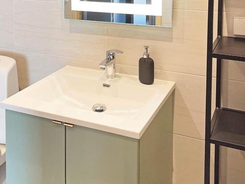 a bathroom sink with a soap dispenser on it at 6 person holiday home in Sollia-By Traum in Brenn