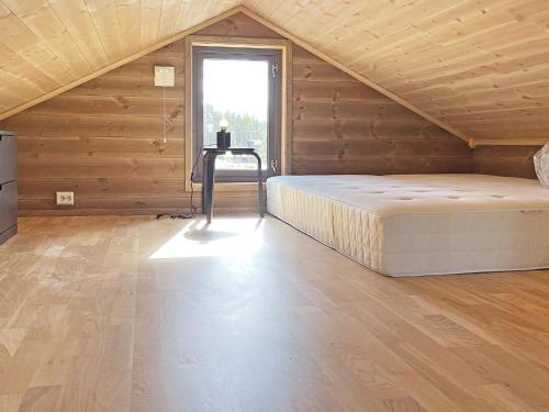 a large bedroom with a bed and a window at Holiday home Sollia in Brenn